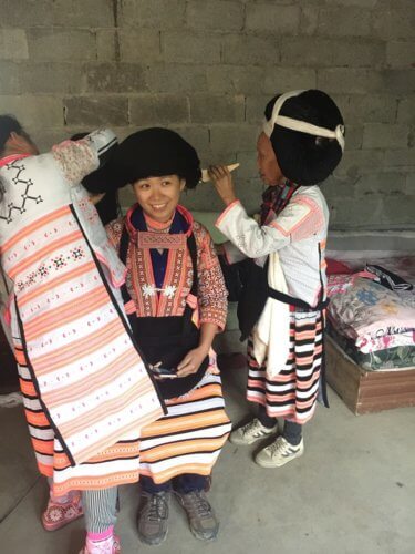 Longhorn Miao putting on headdress